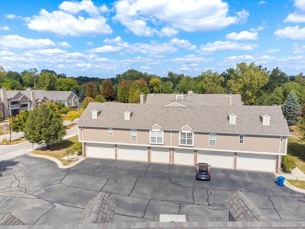 A house with a grey roof and a car in the driveway.