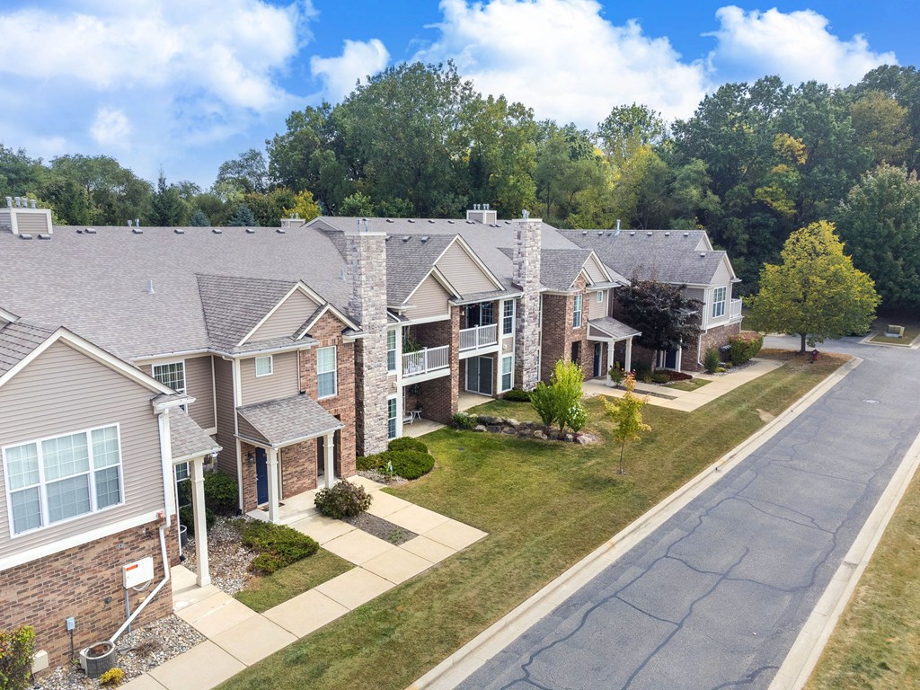 A row of houses with a tree in front of them.