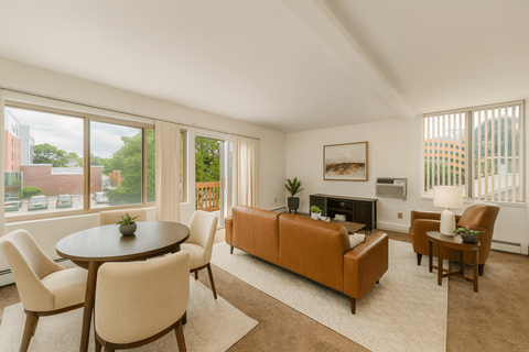 A living room with a brown couch and a coffee table.