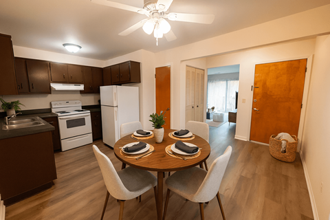 A kitchen with a dining table set for two.