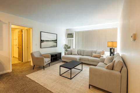 A living room with a couch, chair, and coffee table.