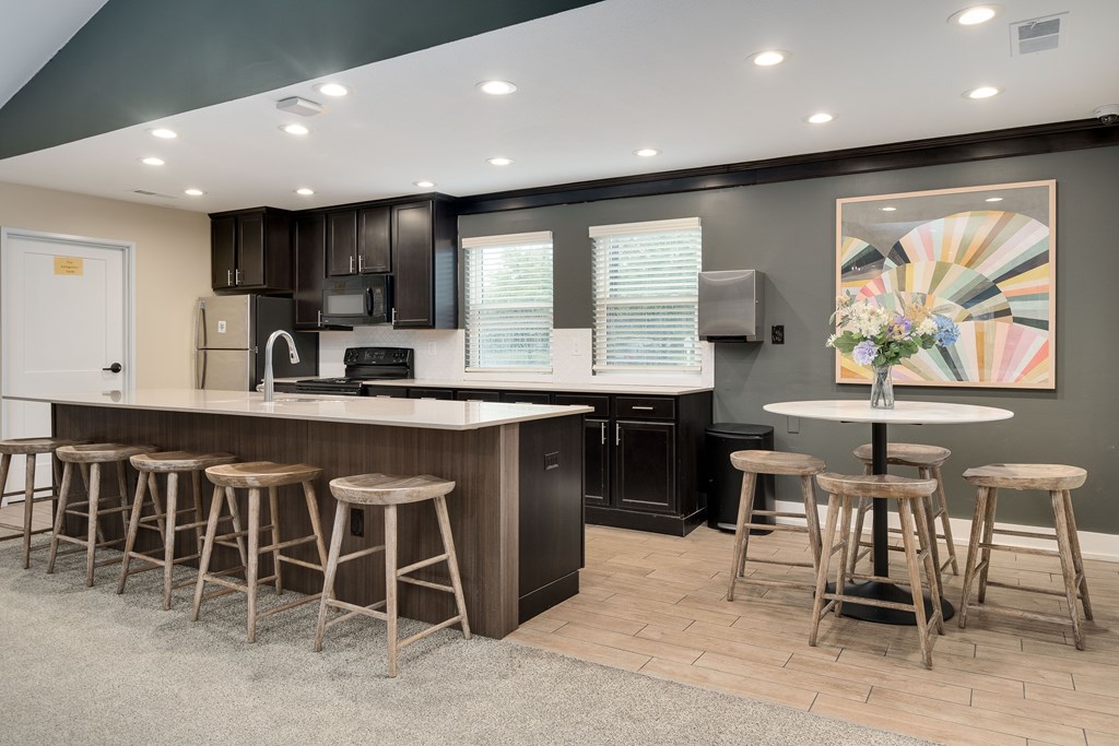 A kitchen with a bar area and stools.