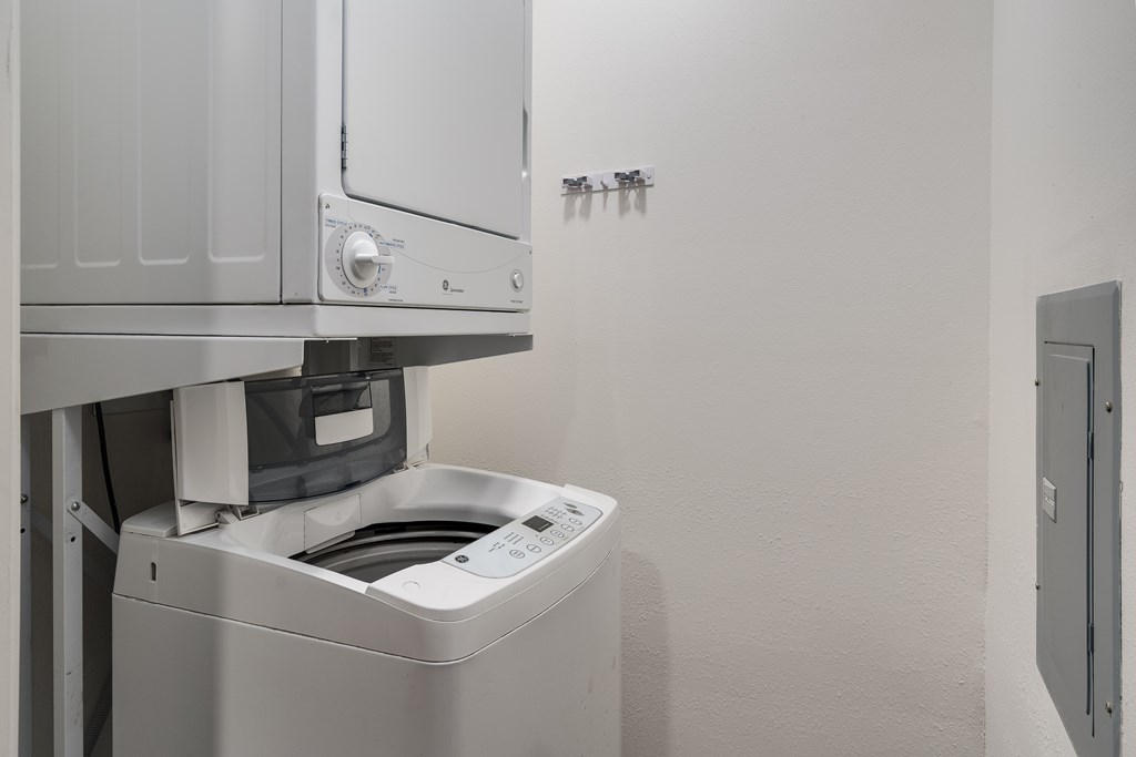 A washing machine is installed in a wall.