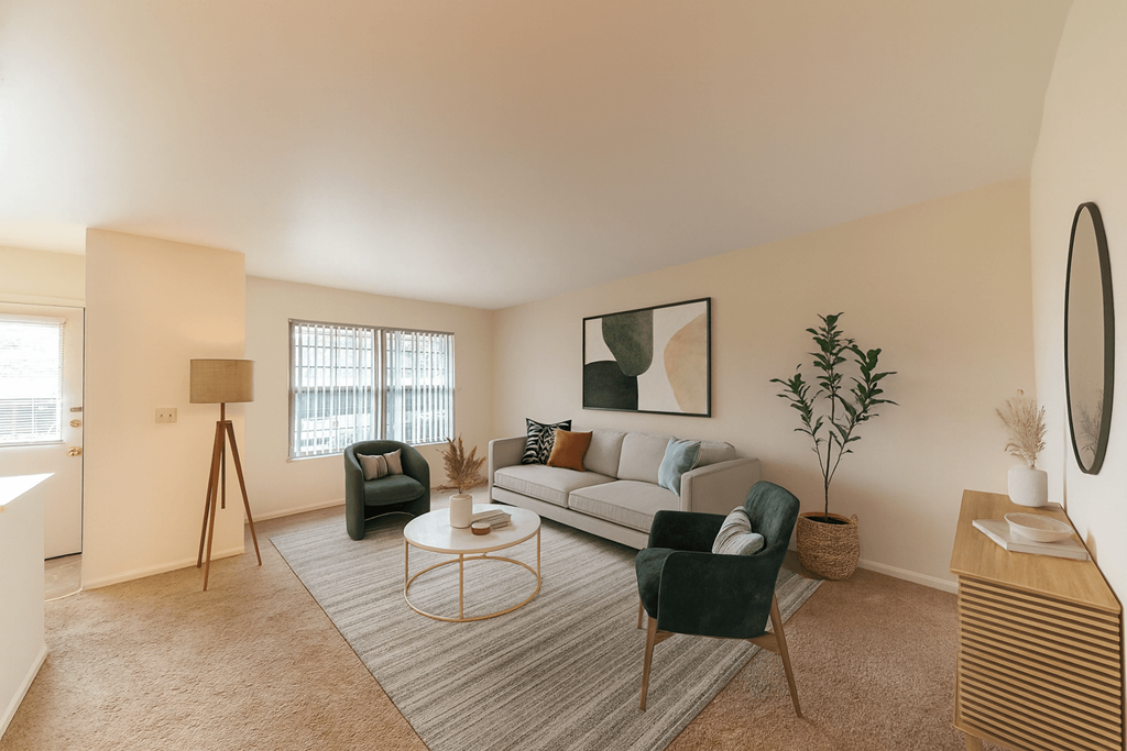 A living room with a couch, chair, and a table.