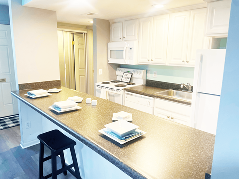 a kitchen with white cabinets and a counter top