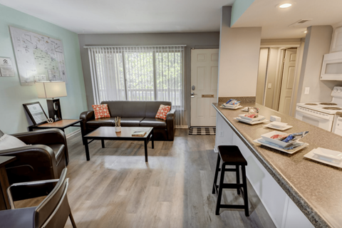 A kitchen with a table and chairs in the middle of the room.