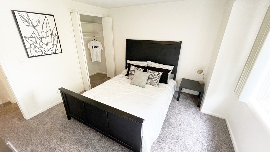 a bedroom with a large bed and a closet