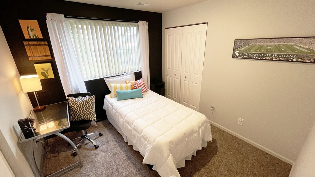 a small bedroom with a bed and a window