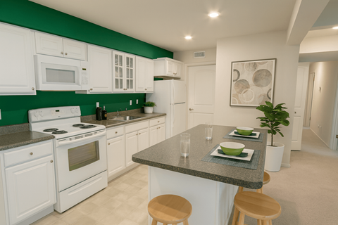 A kitchen with white cabinets and green backsplash.