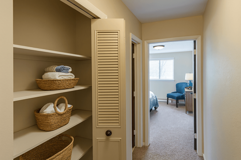 A hallway with a doorway leading to a bedroom.