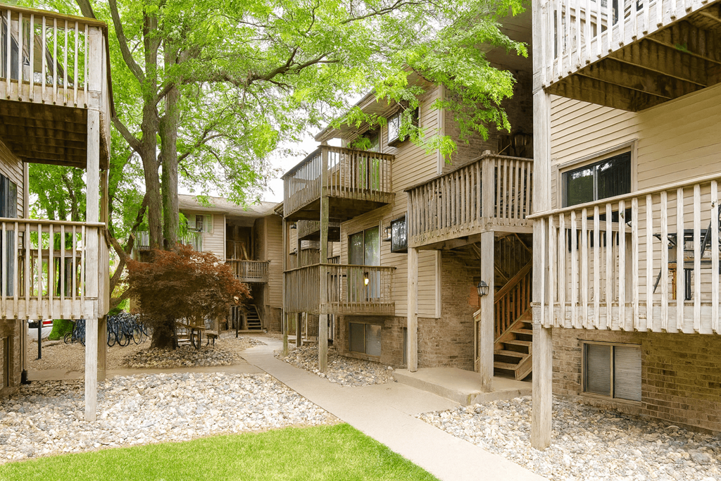 Apartment complex with balconies and trees.
