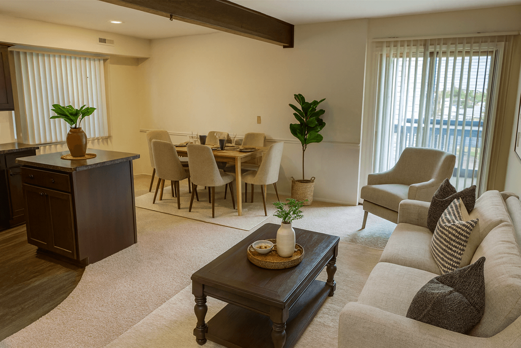 A living room with a brown coffee table and a grey couch.
