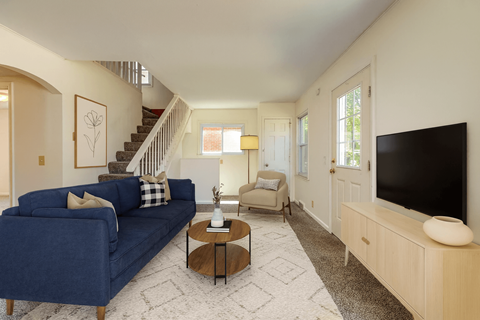 A living room with a blue couch and a television.