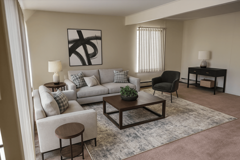 A living room with a grey couch, a black chair, a wooden coffee table, and a painting on the wall.