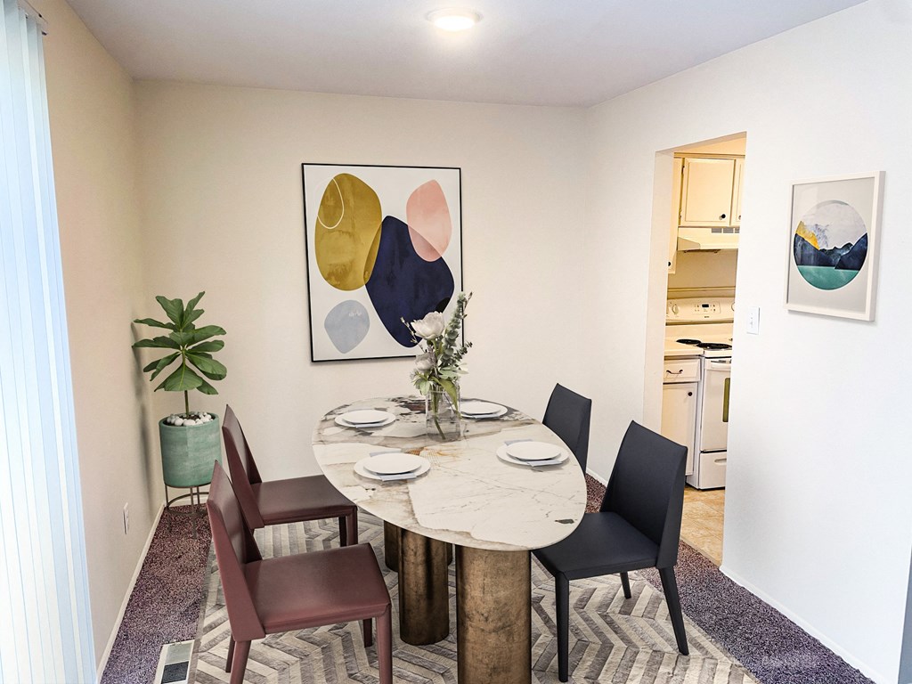a dining room with a table and chairs