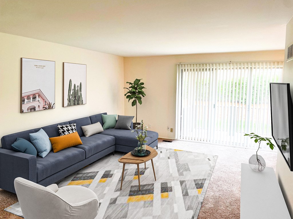 a living room with a blue couch and a rug and a television