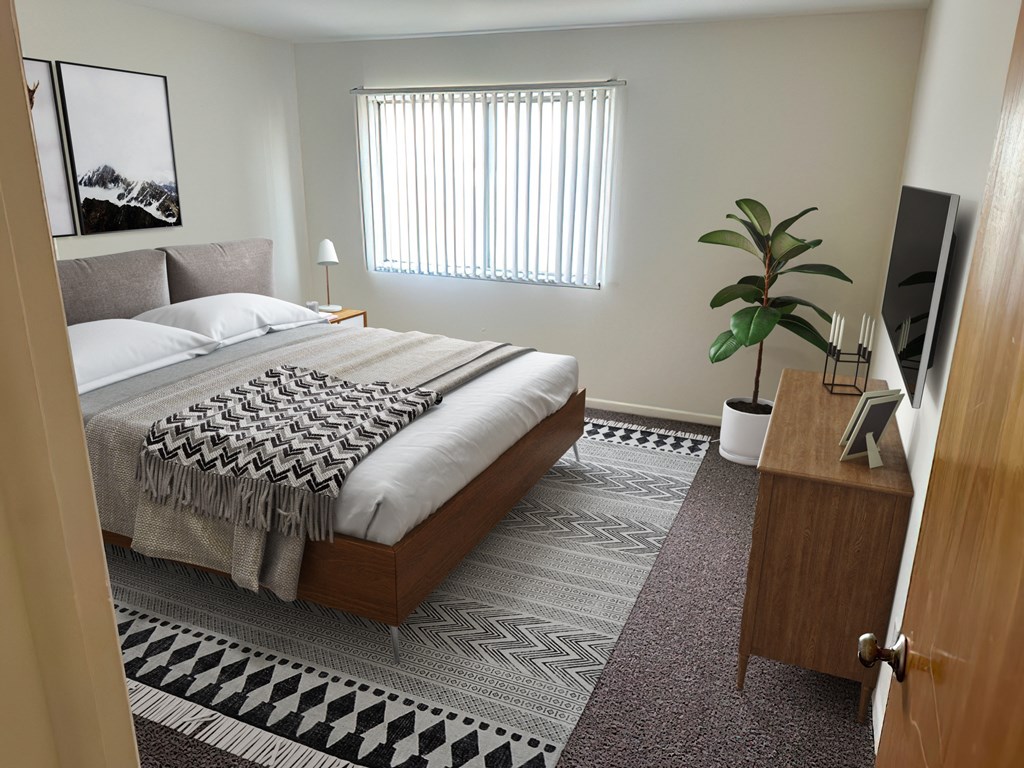 a bedroom with a bed and a plant and a tv