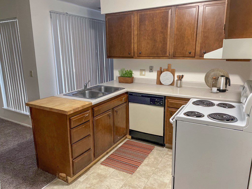 an empty kitchen with a stove and a sink