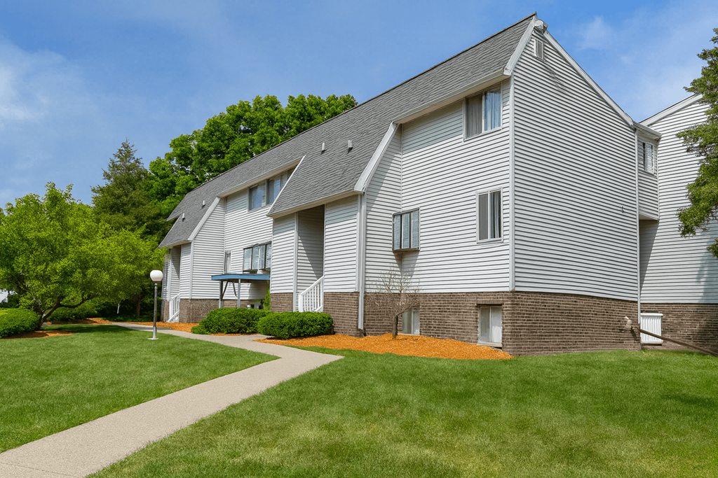 A modern house with a grey exterior and a sloped roof.