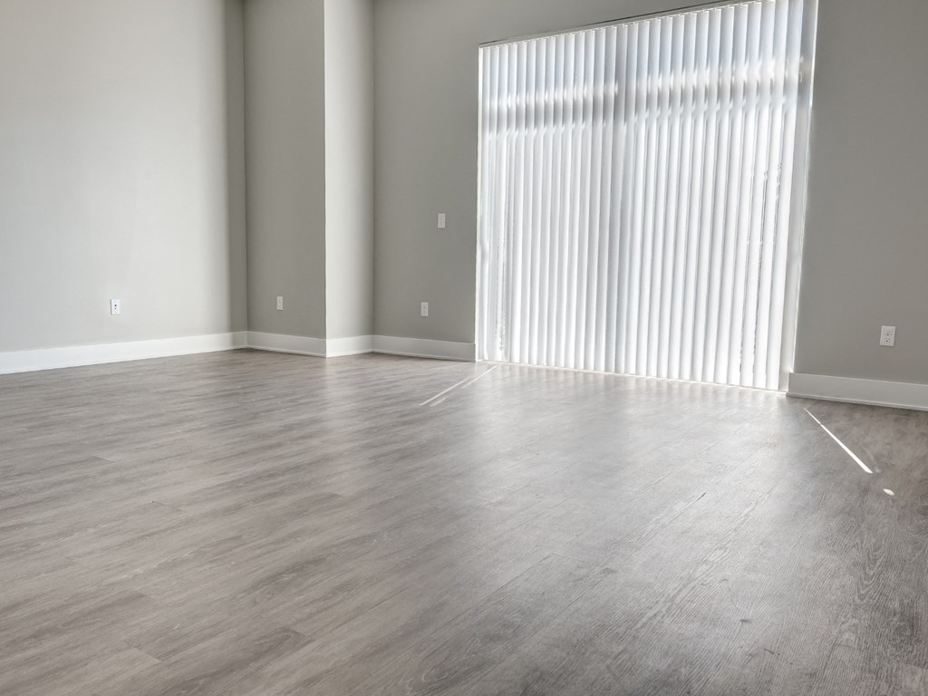 an empty living room with a large window