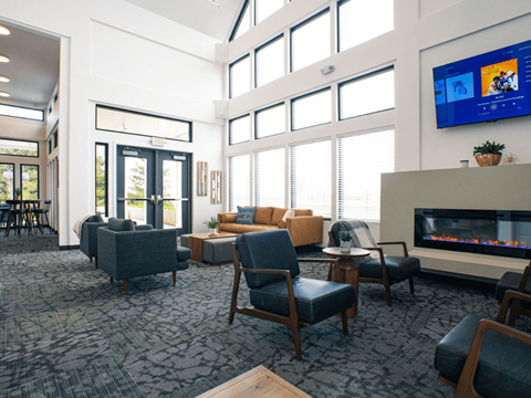 A modern living room with a fireplace and a television.