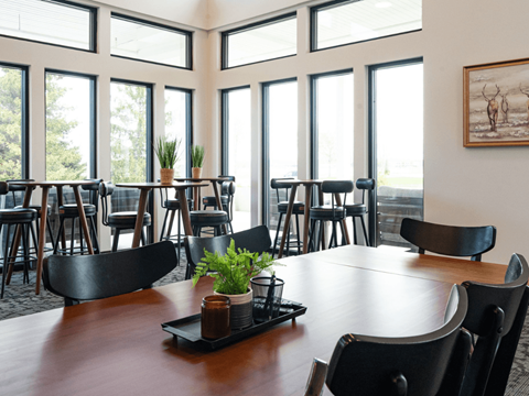 A large conference room with a long table and chairs.