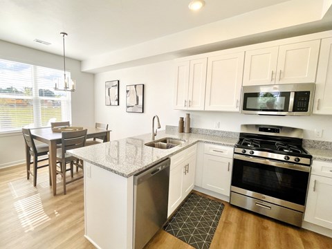 an open kitchen and dining room with a table and chairs