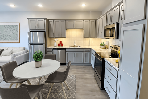 A modern kitchen with a dining table and chairs.