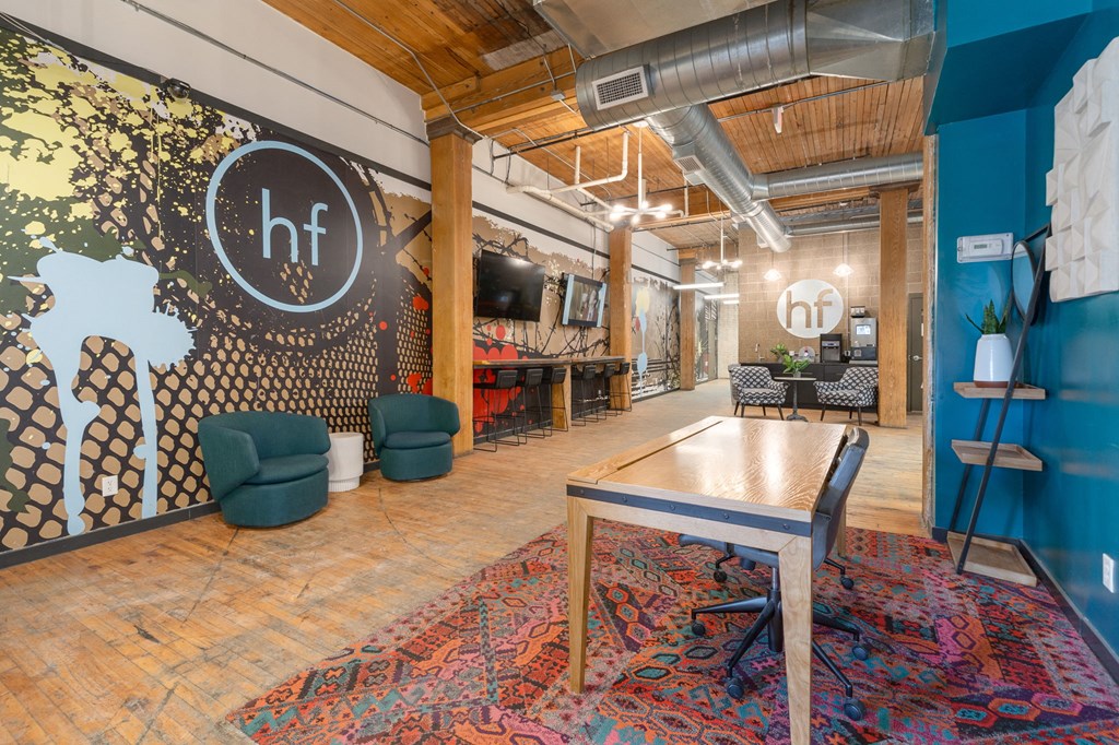 a room with a ping pong table and chairs