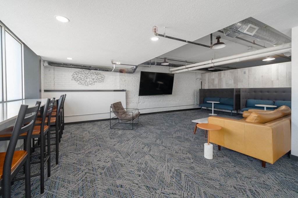 a room with a couch chairs and a table