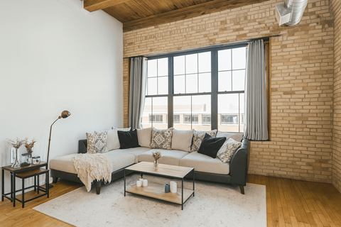 A living room with a grey couch and a coffee table.