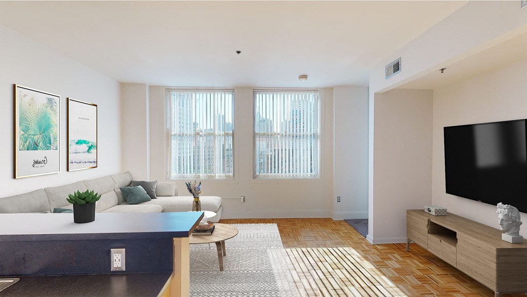 a living room with white walls and hardwood floors