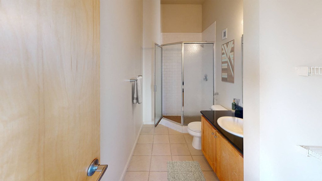 a bathroom with a toilet sink and shower
