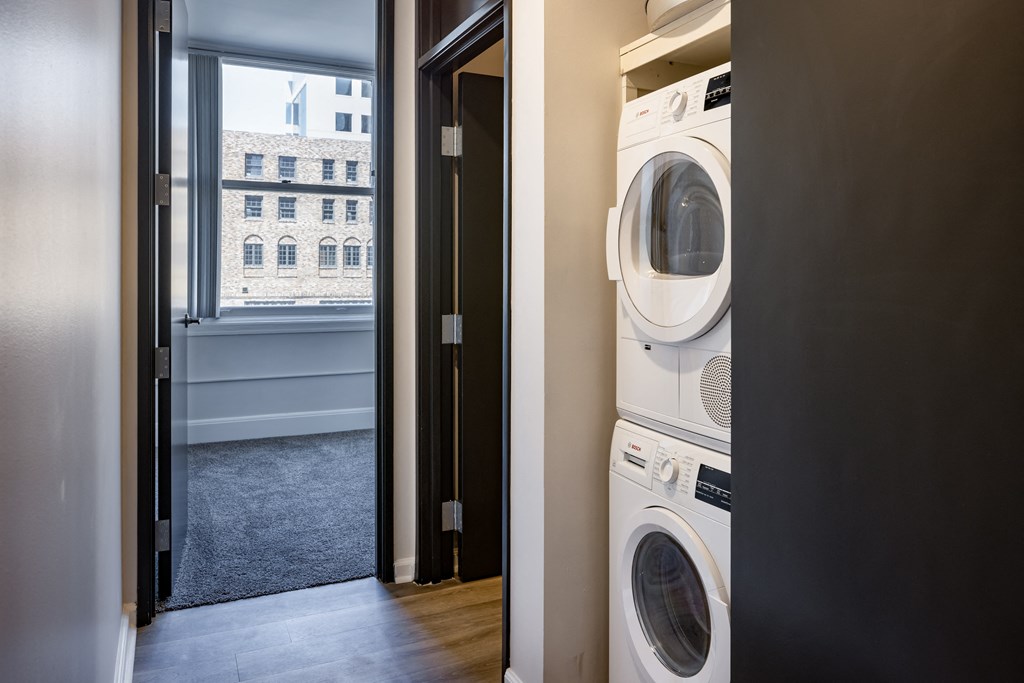 a washer and dryer in a laundry room with a window