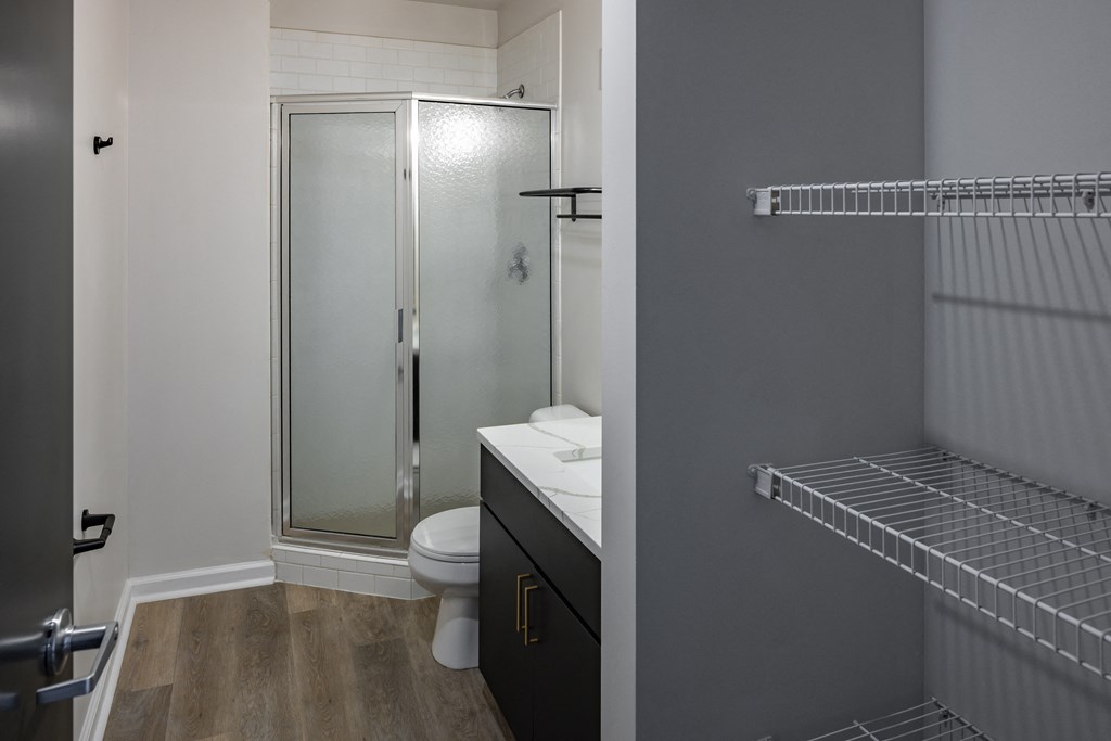 a bathroom with a shower and a sink and a toilet