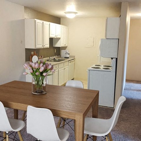 a dining room with a table and chairs and a kitchen