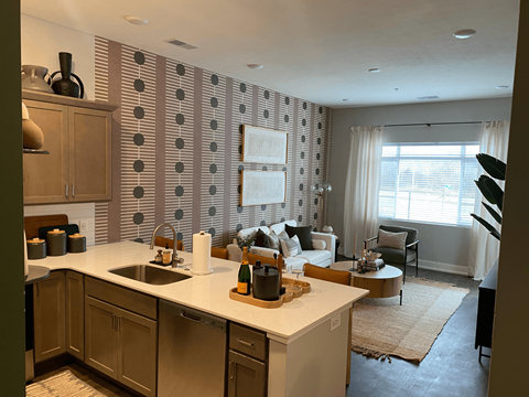 A kitchen with a white counter top and wooden cabinets.