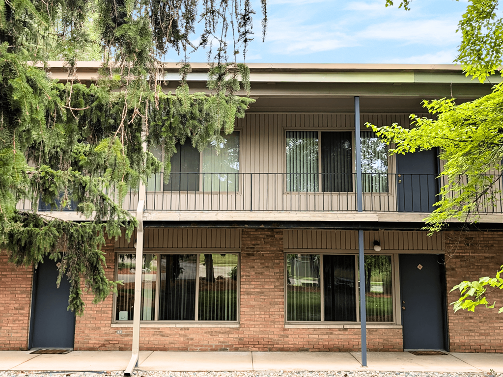 A building with a balcony and a black door.