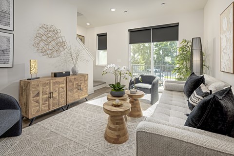 A living room with a grey sofa and a wooden cabinet.