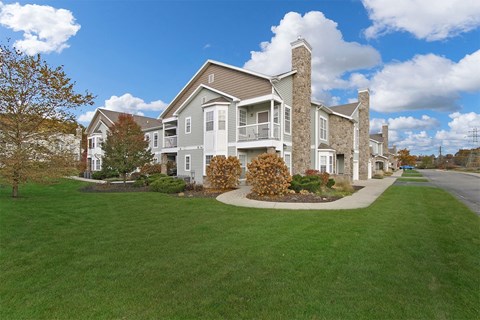 a large green lawn in front of a large house