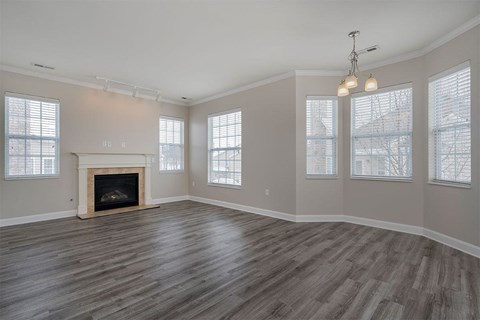 an empty living room with a fireplace
