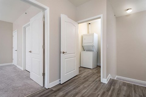 a bedroom with a washer and dryer