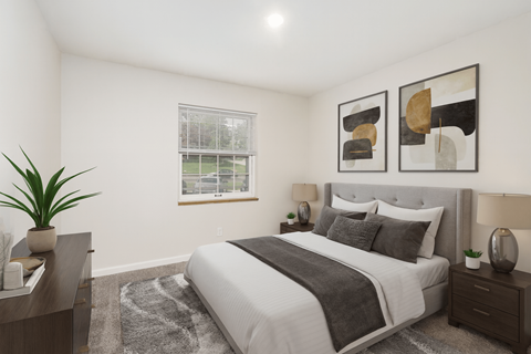 A bedroom with a large bed, a nightstand, and a plant.