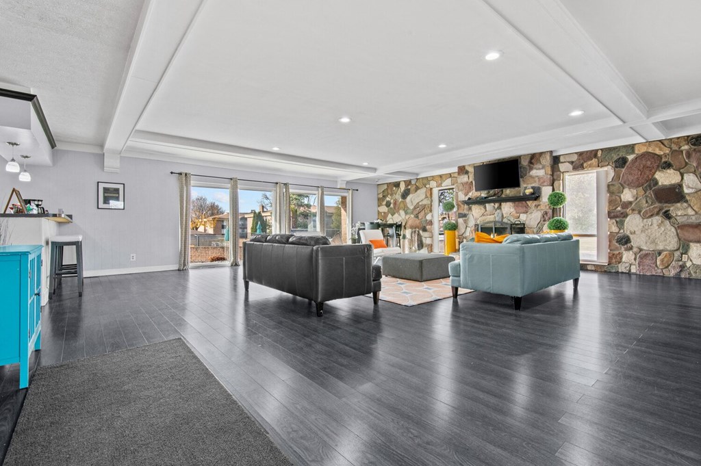 the living room has a stone wall and two couches