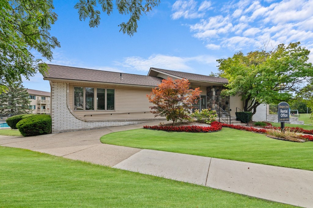 the front of a house with a yard and grass