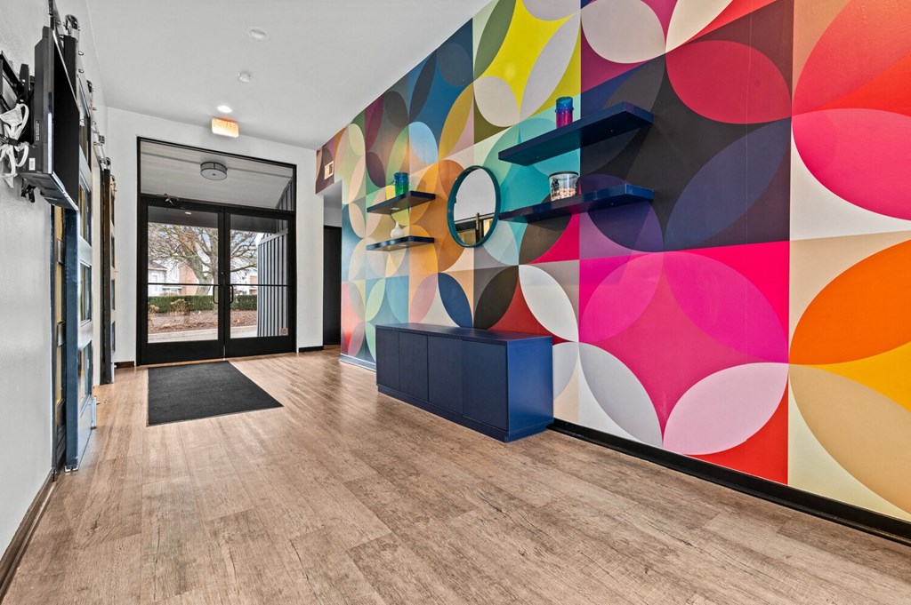 a hallway with a colorful mural on the wall and a door