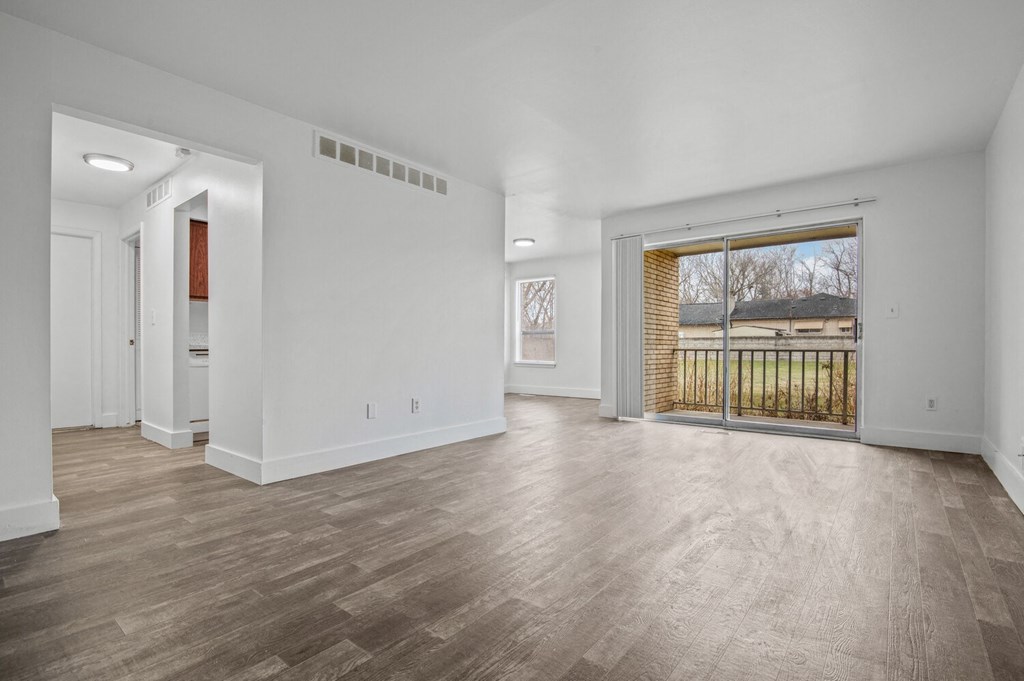the living room of a new home with a large door to the backyard