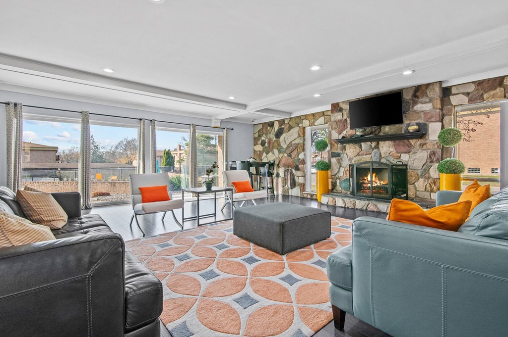 a living room with couches and chairs and a fireplace