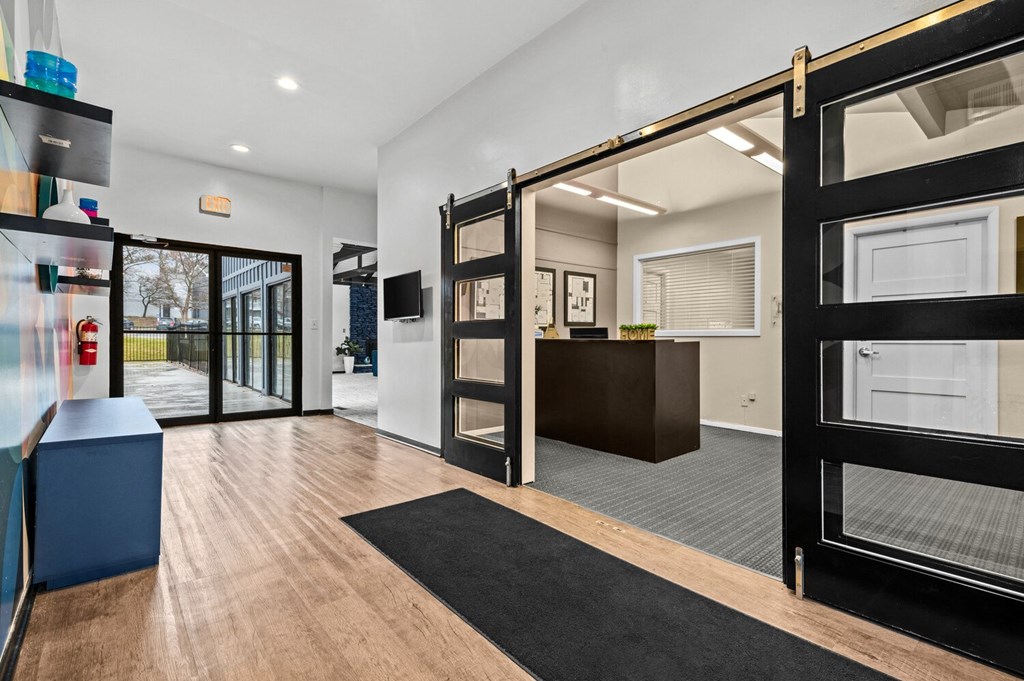 a living room with a sliding glass door and a kitchen with a counter and a