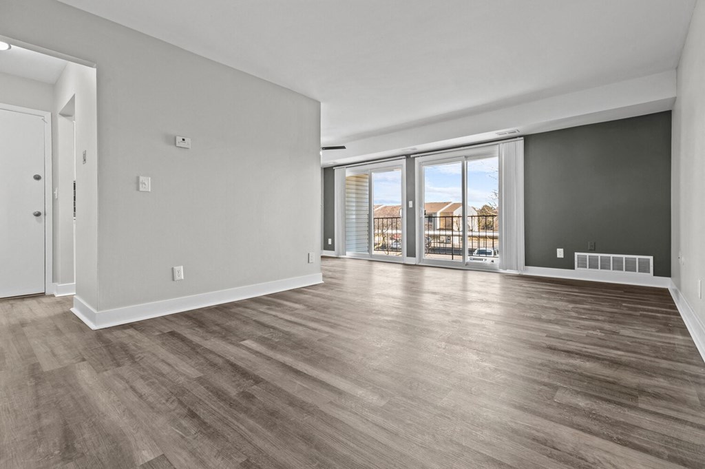 an empty living room with a view of a window at Sunnymede Apartments - Troy, MI, Troy, Michigan